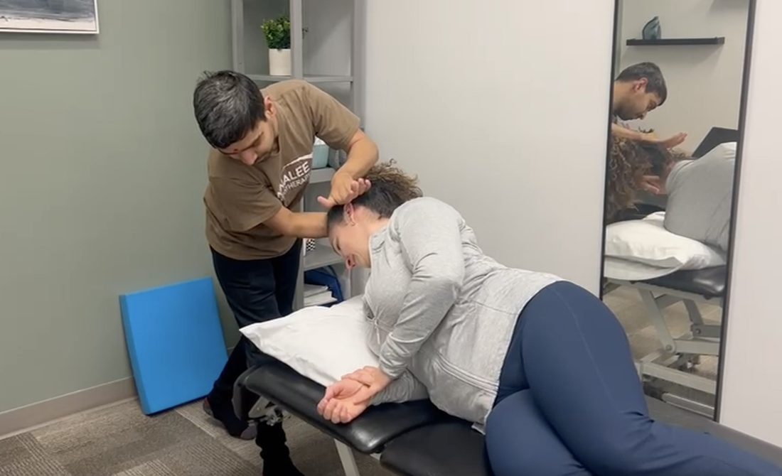 Physiotherapist guiding a patient through a vestibular and balance exercise